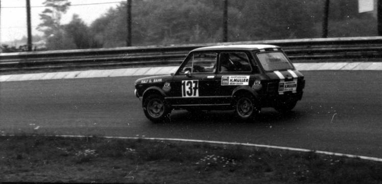 A small Autobianchi A112 saloon, race number 137, cornering on the Nordschleife with "Ralf G. Bahr" lettered on the door.