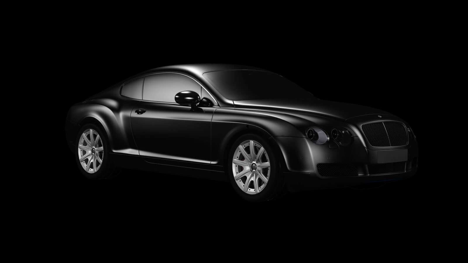 Black grand-touring coupe presented in a dark studio.