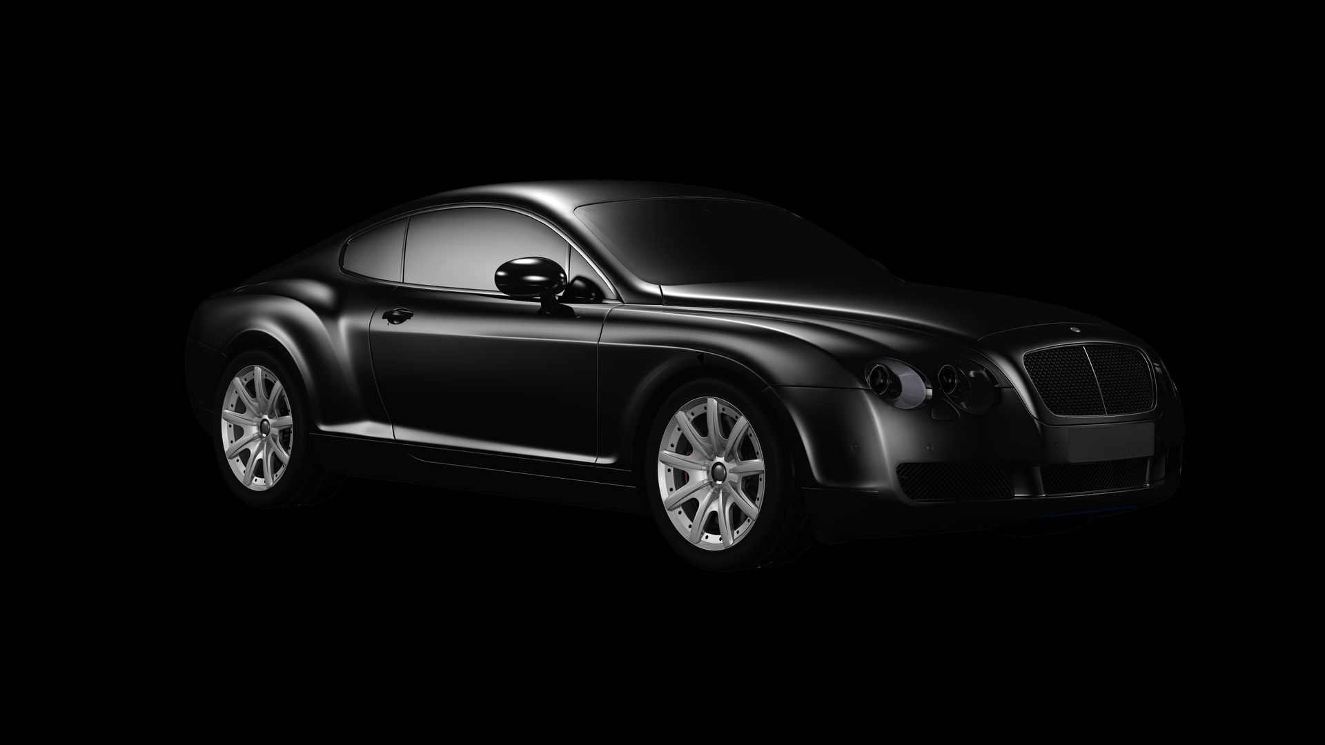 Black grand-touring coupe presented in a dark studio.